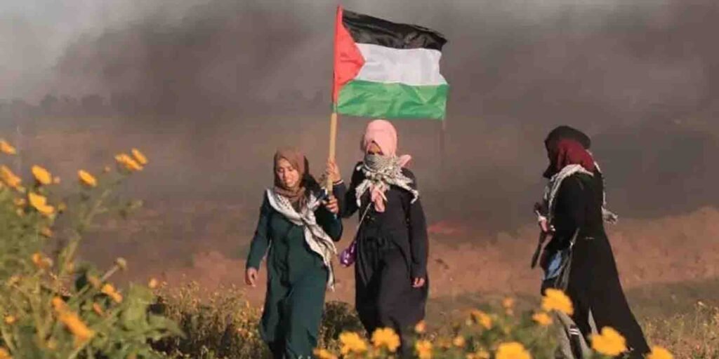 فلسطینی یوم الارض پر جھنڈا لہراتے مظاہرین